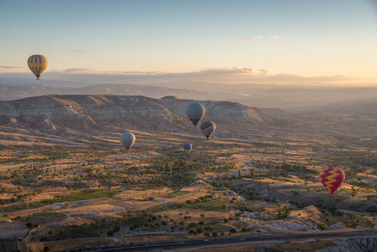Scenic picture with baloons flying over Cappadocia landscape at sunrise
