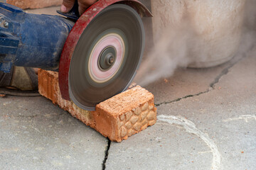 The process of sawing bricks with a grinder with a diamond disc