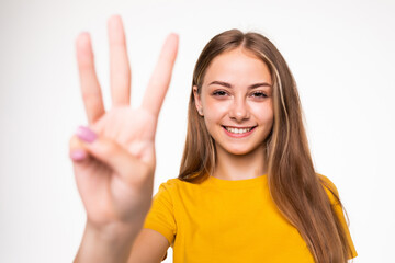Young woman showing number three on white background