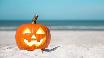 Halloween party on the beach. Pumpkin Jack-o'-lantern. Jack o lantern for Happy Halloween. Autumn season. On background ocean. Autumn in Florida. Fall season. Copy space. © artiom.photo