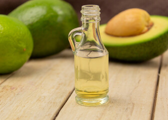Healing avocado oil on a wooden background