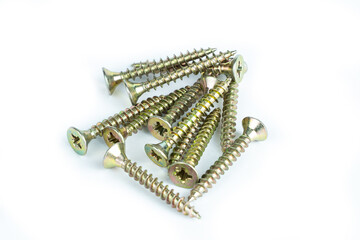 A mountain of yellow metal screws on a white background. Blank for insertion. Metalware.