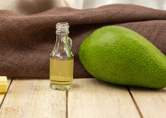 Healing avocado oil on a wooden background