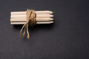 Bundle of colored pencils wrapped with linen string