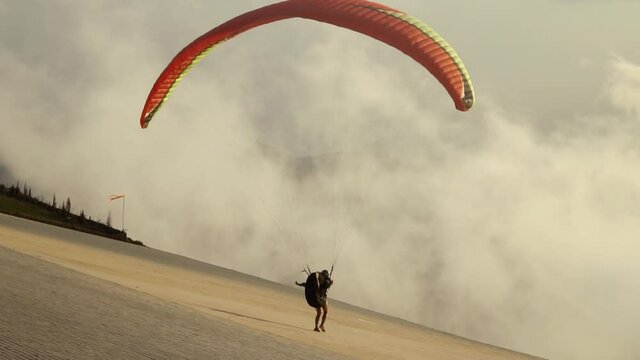 Silhouette man take off on paragliding at sunset. Paraglide flight experience skydive summer