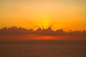 Beautiful sunset above the sea. Gorgeous panorama scenic of sunrise with cloud on the orange sky.