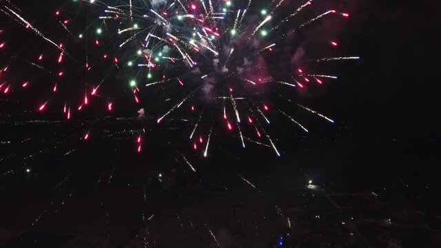 Fireworks explode over town in Utah, wide aerial