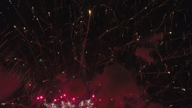 Colorful fireworks explode in Utah night sky, wide aerial