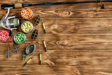 Accessories for carp fishing and fishing baits on wooden planks with copy space
