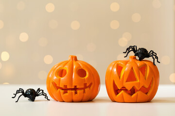 Halloween pumpkins with spider on a shiny light background
