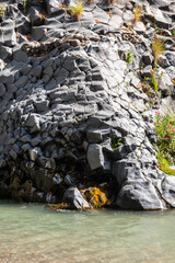 Basalt rocks and pristine water of Alcantara gorges in Sicily, Italy