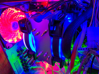 Modern computer air cooling with multi-colored led backlight-fans, cooling radiators, cables, boards, close-up, macro.