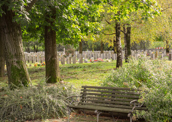 nice view from the bench on a well kept public cemetery located in a city park in the autumn season
