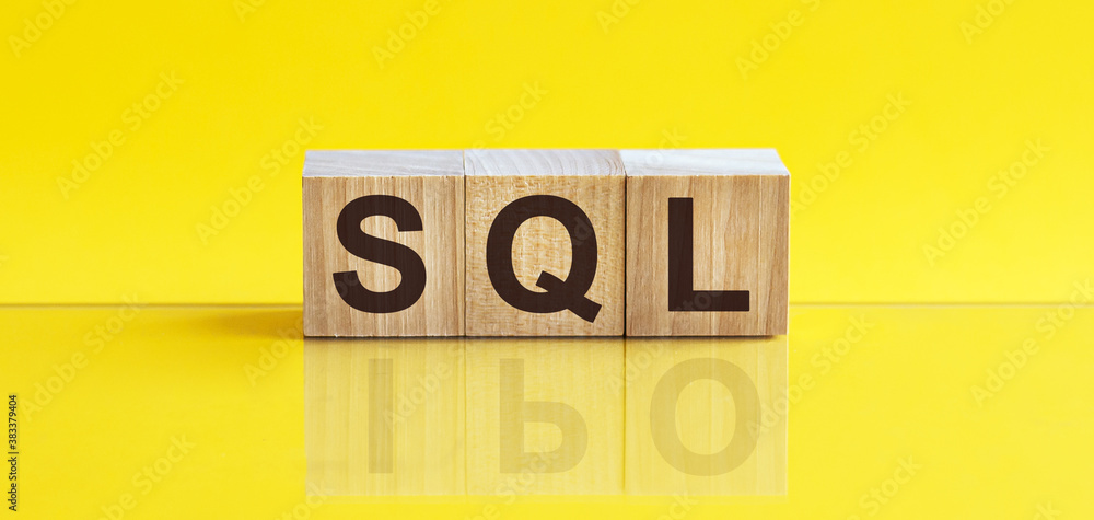 Poster sql word is made of wooden building blocks lying on the yellow table
