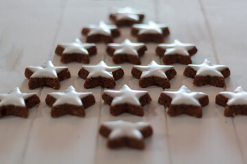 Christmas tree made with heart shaped cookies on white wooden table