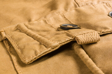 clothing items stonewashed cotton fabric texture with seams, clasps, buttons and rivets, macro