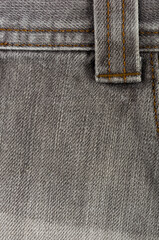 clothing items stonewashed cotton fabric texture with seams, clasps, buttons and rivets, macro