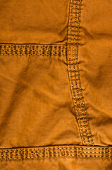 clothing items stonewashed cotton fabric texture with seams, clasps, buttons and rivets, macro