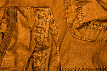 clothing items stonewashed cotton fabric texture with seams, clasps, buttons and rivets, macro