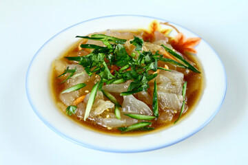 Chinese jellyfish salad in a bowl close up