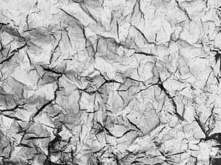A greyscale rough, creased abstract digital collage texture. Ideal for use as a background image.