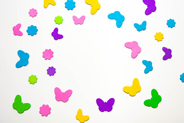 Fluttering butterflies over colorful flowers on a white background.