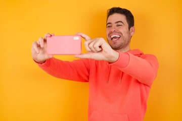 MODEL taking a selfie to post it on social media or having a video call with friends.