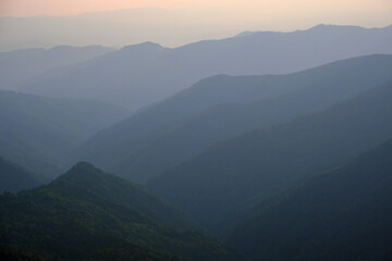 Summer misty evening mountain tops silhouettes. Marmaros, Carpathian, Ukraine.
