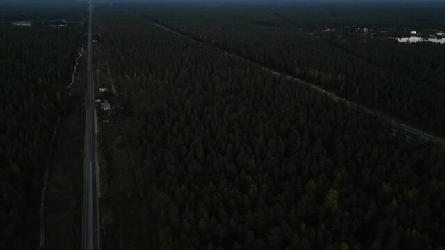 Aerial strafe right: Drone flight over railway to highway with cards