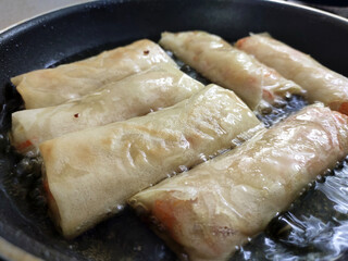 Popiah or spring rolls are cooked using hot cooking oil and presented to eat.. It comes with a variety of filling.  