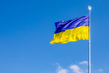 yellow-blue Ukrainian flag against the blue sky