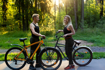 Couple in love on bikes in the woods in the park