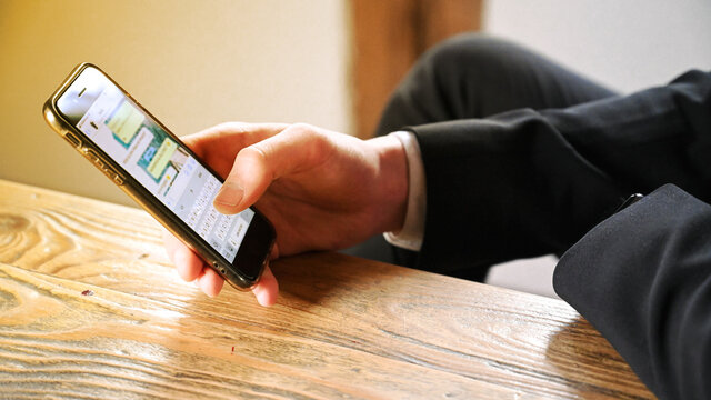 Businessman using digital smartphone on chat messenger - Powered by Adobe