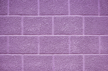 Fototapeta premium purple wall of the house on the street. the plaster has a texture and is covered with paint. beautiful background