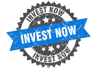 invest now stamp. grunge round sign with ribbon