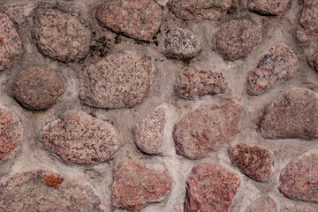 Texture of stone, large stones bound by cement.
