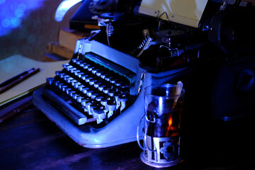 old typewriter on desk, telephone, mystery detective concept, writer's work tools, blue backlight