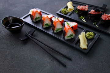 Seafood delicatessen sushi rolls set on plates. Different gourmet snacks. Japanese restaurant menu, food delivery