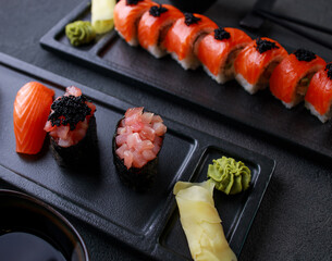 Seafood delicatessen sushi rolls set on plates. Different gourmet snacks. Japanese restaurant menu, food delivery