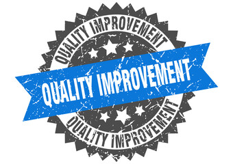 quality improvement stamp. grunge round sign with ribbon