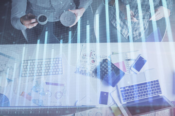 Double exposure of man and woman working together and financial chart hologram drawing. market analysis concept. Computer background. Top View.