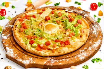 Pizza with bacon meat, egg yolk and green salad
