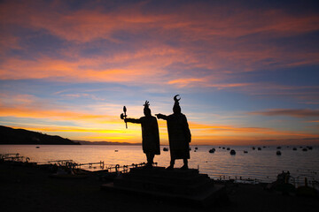 Silhouette of Inca statues during sunset over Lake Titicaca in Copacabana, Bolivia