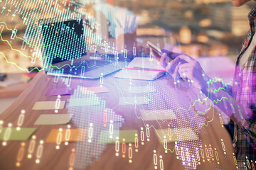 Double exposure of woman hands working on computer and forex graph hologram drawing. Financial analysis concept.