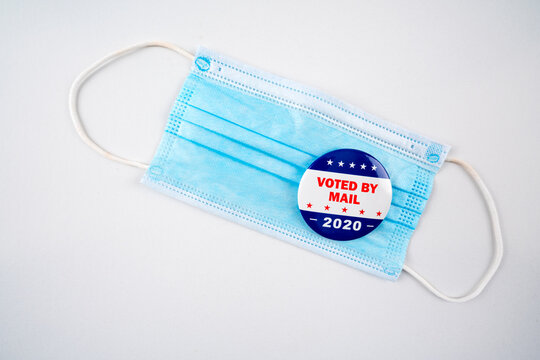 Face mask with american flag colored button with the text voted by mail 2020..Voting, covid-19 and presidential election concept 2020.