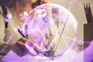 Double exposure of woman hands typing on computer and financial graph hologram drawing. Stock market analysis concept.