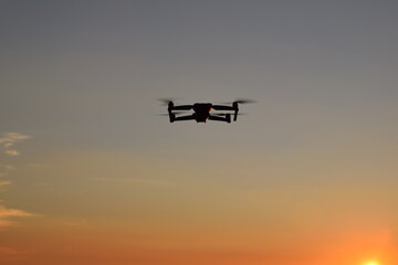 Fototapeta na wymiar Small Drone in Sky at Sunrise