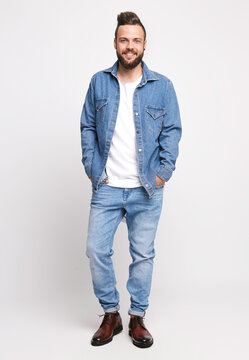 Young man in denim suit. Handsome man in denim jacket and jeans on a white background. Photo for advertising men's jeans and jackets. Concept for advertising