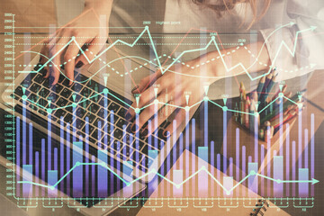Double exposure of woman hands typing on computer and forex chart hologram drawing. Stock market...