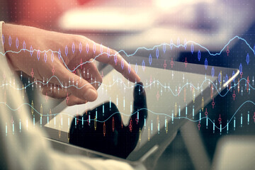Multi exposure of man's hands holding and using a phone and financial chart drawing. Market analysis concept.